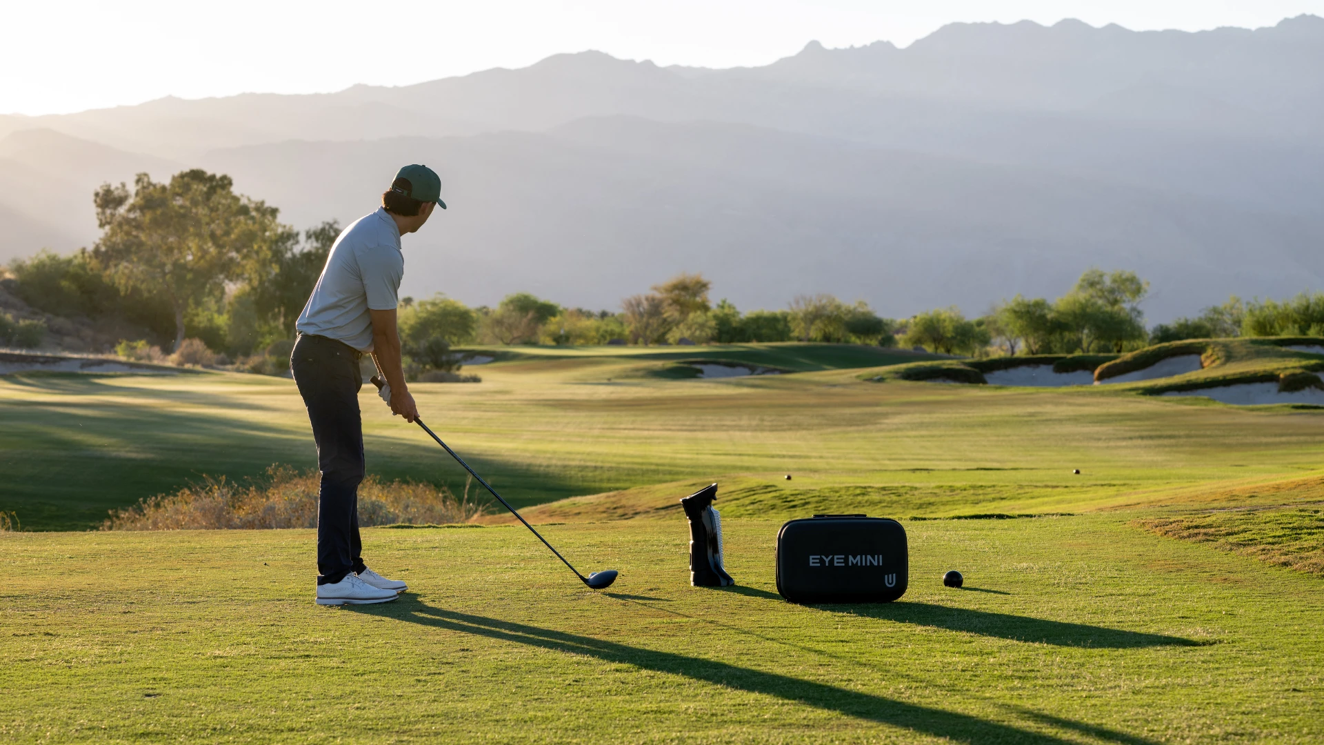 Golfer with Uneekor EYE MINI Launch Monitor